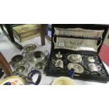 A cased white metal hot chocolate set,