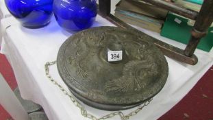 A Chinese cast bronze gong decorated with dragons,