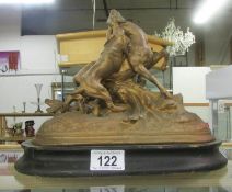 A gilded spelter figure group of a dog attacking a deer,