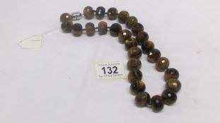 A natural tiger's eye necklace with silver clasp