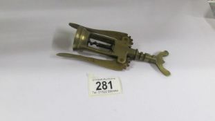 A vintage brass corkscrew