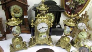 A 3 piece gilt & porcelain clock garniture