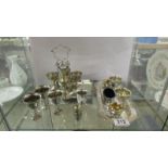 A mixed lot of silver plate egg cups on stands etc