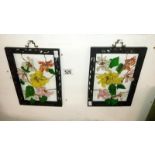A pair of metal framed floral collages