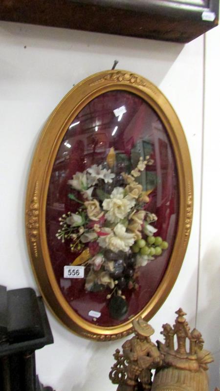 A gilt framed floral arrangement