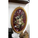 A gilt framed floral arrangement