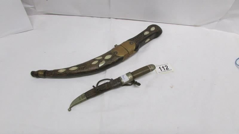 An Eastern dagger inlaid with mother of pearl and brass together with a skinning knife