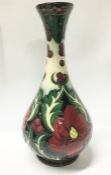 A boxed Moorcroft ruby vase signed by Rachel Bishop