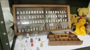A quantity of collector's thimbles in display cabinets
