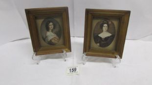 A pair of framed and glazed miniature portraits of ladies