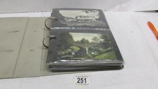 An album of approximately 100 postcards, topographical, local,