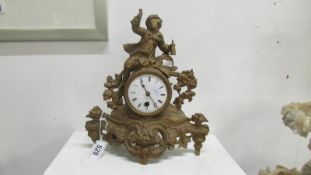 A spelter clock surmounted figure