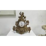 A spelter clock surmounted figure