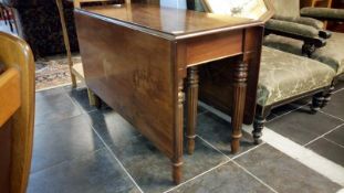 A 19th century mahogany drop leaf table on reeded legs