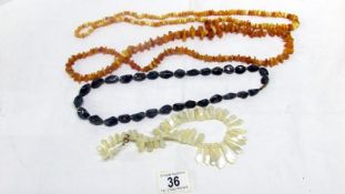 2 yellow amber necklaces,