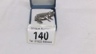 A silver pig brooch