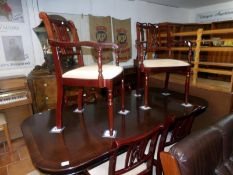 A mahogany effect dining table and 6 chairs
