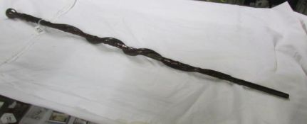 A carved walking stick with entwines snake A/F