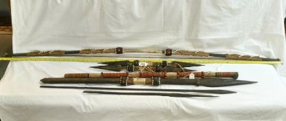 A quantity of 1920's/30's ethnographic heavy palm wood tribal weapons including long bow,