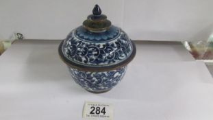 An early soft paste lidded pot with brass banding (a/f)