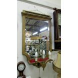 A gilt framed mirror with lights