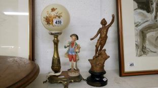A French spelter figure & a spelter lamp with bisque flower seller figurine