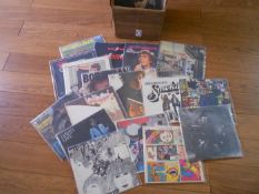 A box of apporximately 60 rock and folk LP records including The Beatles, The Who, David Bowie,