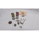 A defence medal, war medal, dog tag,