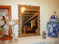 A gilt framed mirror