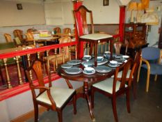 A good mahogany dining table with claw feet & 6 chairs including 2 carver chairs