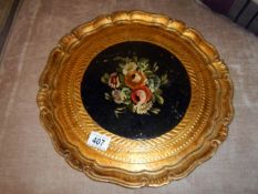 A gilt pie crust tray with painted centre piece of flowers