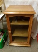 An oak glazed music cabinet