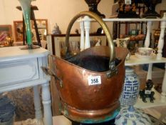 A copper coal scuttle