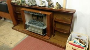 A wooden fire surround and electric fire