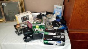 A quantity of boxed digital cameras etc