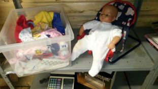 A dolls chair and clothes