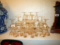 A large quantity of retro glasses with gold banding