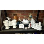 A shelf of pottery etc
