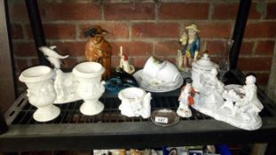 A shelf of pottery etc