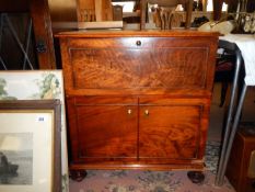 A mahogany cupboard with pulldown front & 2 doors