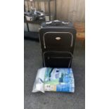 A large suitcase & a caravan top cover