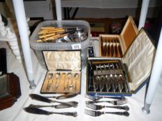 A large quantity of cutlery including cased sets