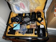 A cased set of photographic equipment Yashica camera lenses etc