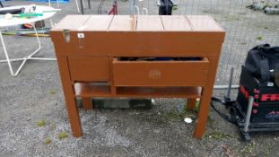 A wooden work bench with tools