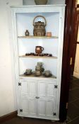 A shabby chic corner cabinet