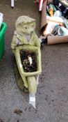 A hedgehog with wheelbarrow garden planter