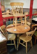 A round pine kitchen table with 4 beech kitchen chairs