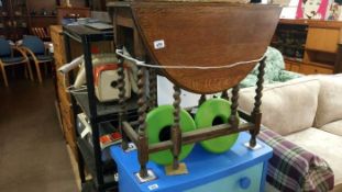 A drop leaf table with Barley twist legs