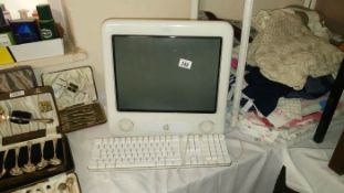 A Apple Emac computer with keyboard