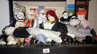 A shelve of Clown & Pierrot Dolls etc